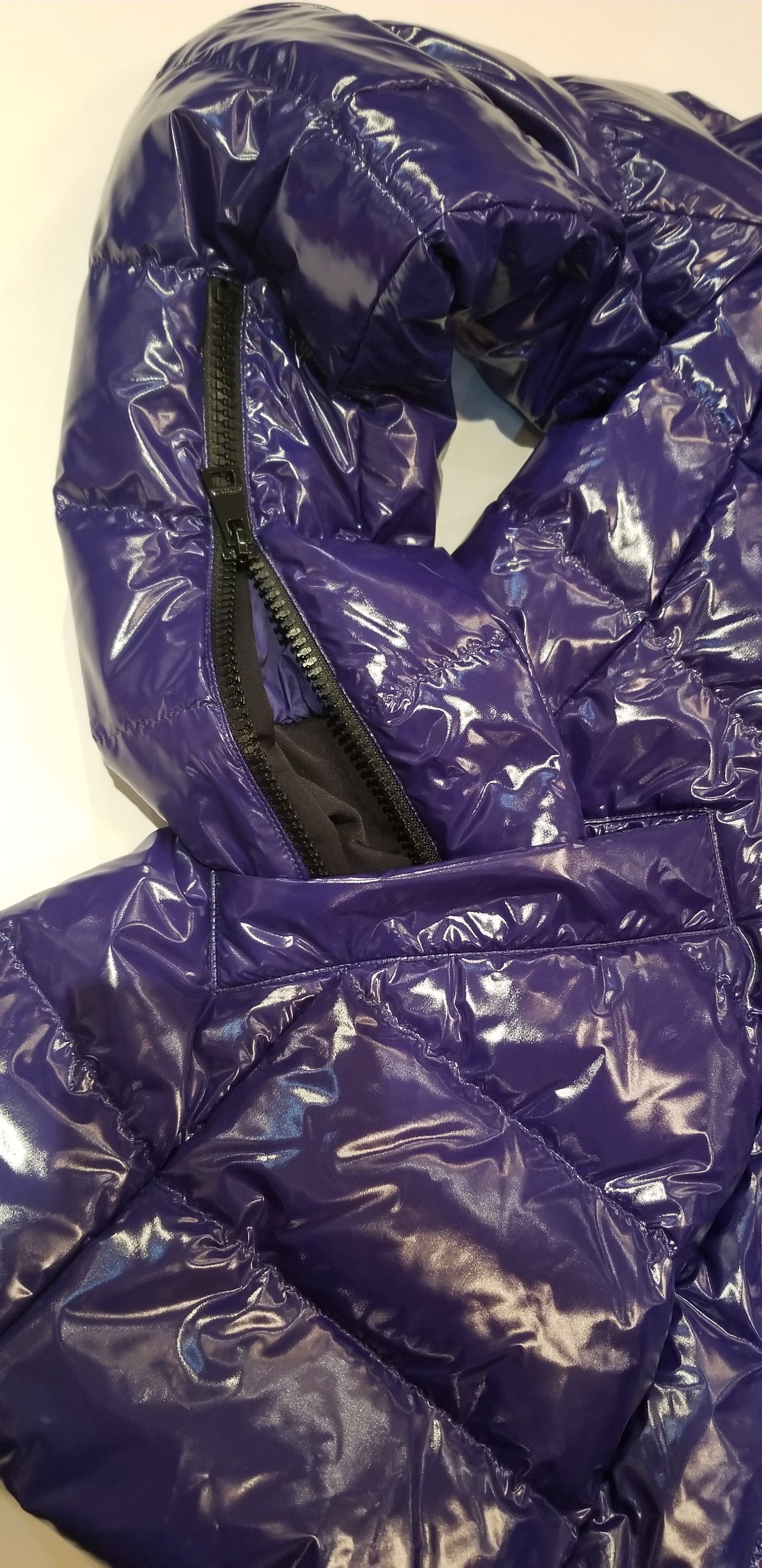 Close-up of Marccain royal blue reversible quilted jacket showing zipper details and glossy finish.