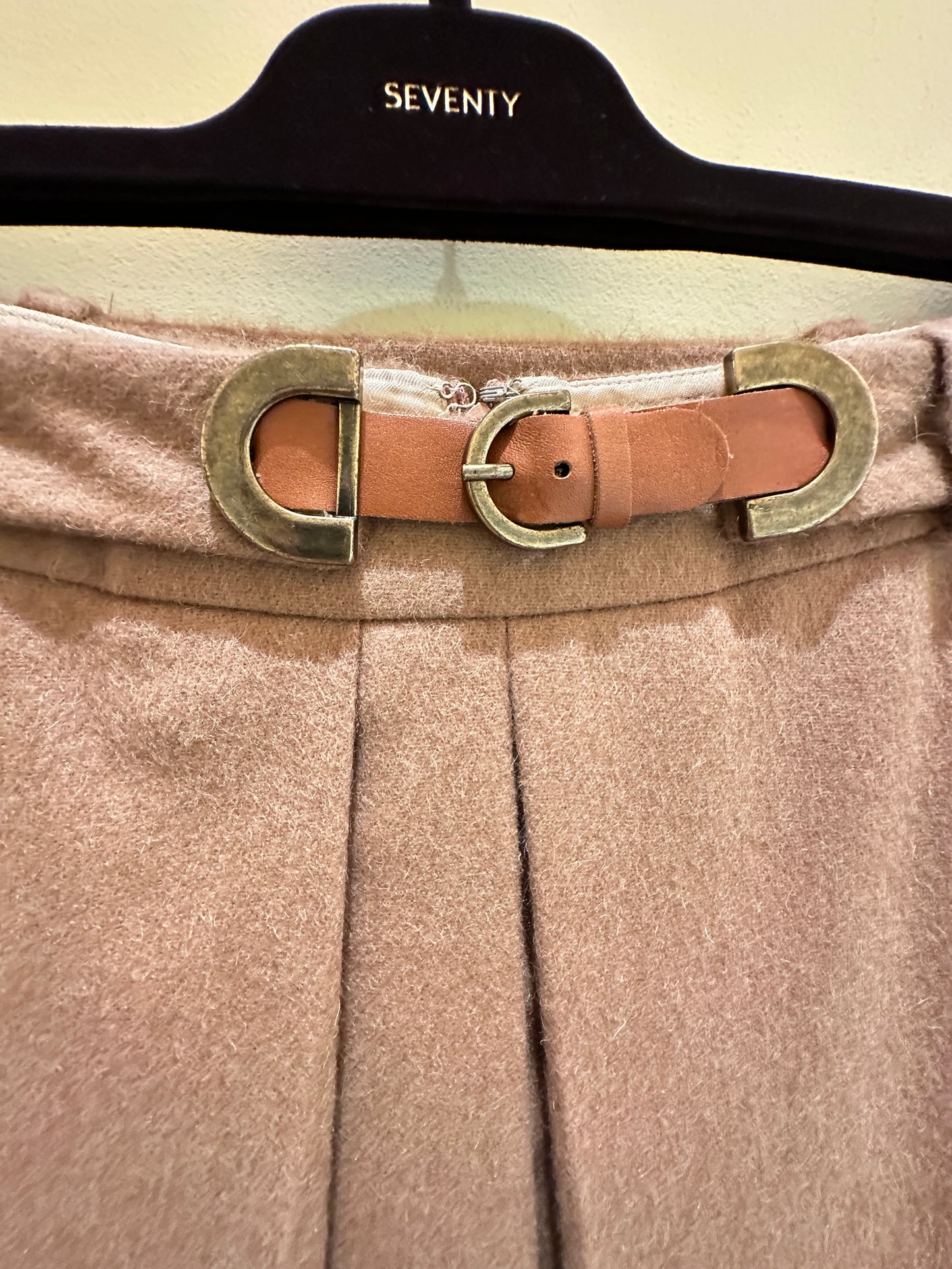 Close-up of the Seventy A-Line Skirt's waist with a stylish belt and buckle detail on a hanger.