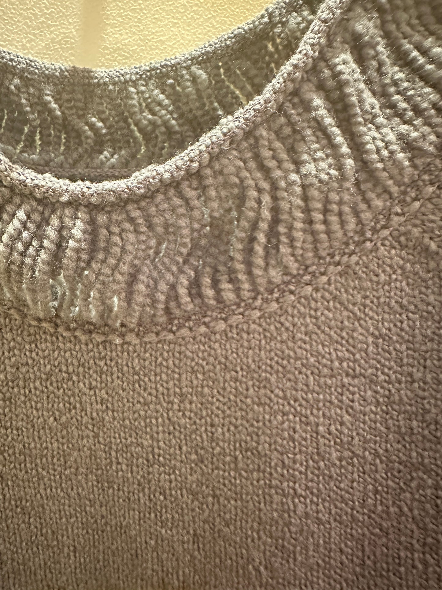 Close-up of the thread neckline detail on a Marccain Sweater in gray, showcasing premium fabric and craftsmanship.