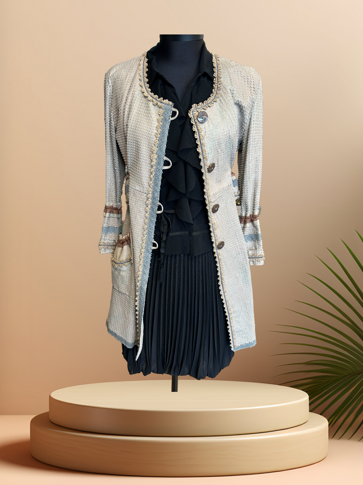 Save the Queen Leather coat displayed on a mannequin, featuring a stylish design and lightweight fabric, perfect for spring.