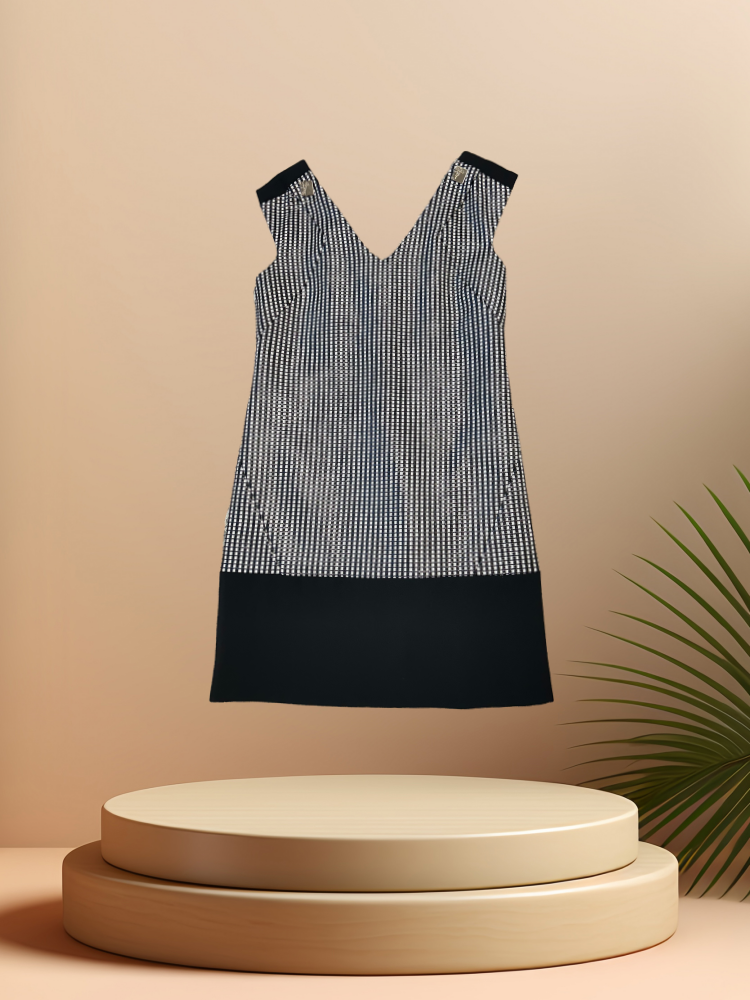 Versace black and white checked dress displayed on a pedestal, showcasing its elegant design and craftsmanship.