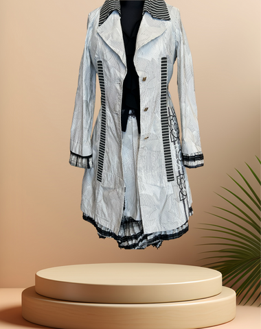 Save the Queen Black & White Stripped Coat displayed on a pedestal, perfect for spring fashion.