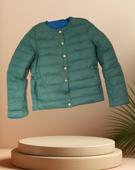 Escada Reversible Puffer jacket in teal, featuring button closures and a cozy design for warmth and style.