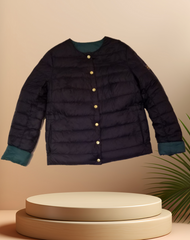 Escada Reversible Puffer jacket in dark color with buttons, showcasing warmth and style for cold weather.
