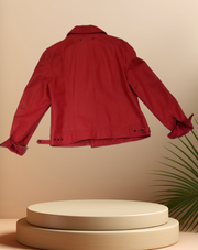 Back view of a red Marccain leather jacket displayed on a pedestal against a soft backdrop.