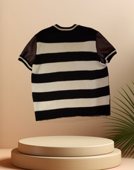 Marccain leather blouse featuring stylish black and white stripes, blending luxury leather and cozy knitting.