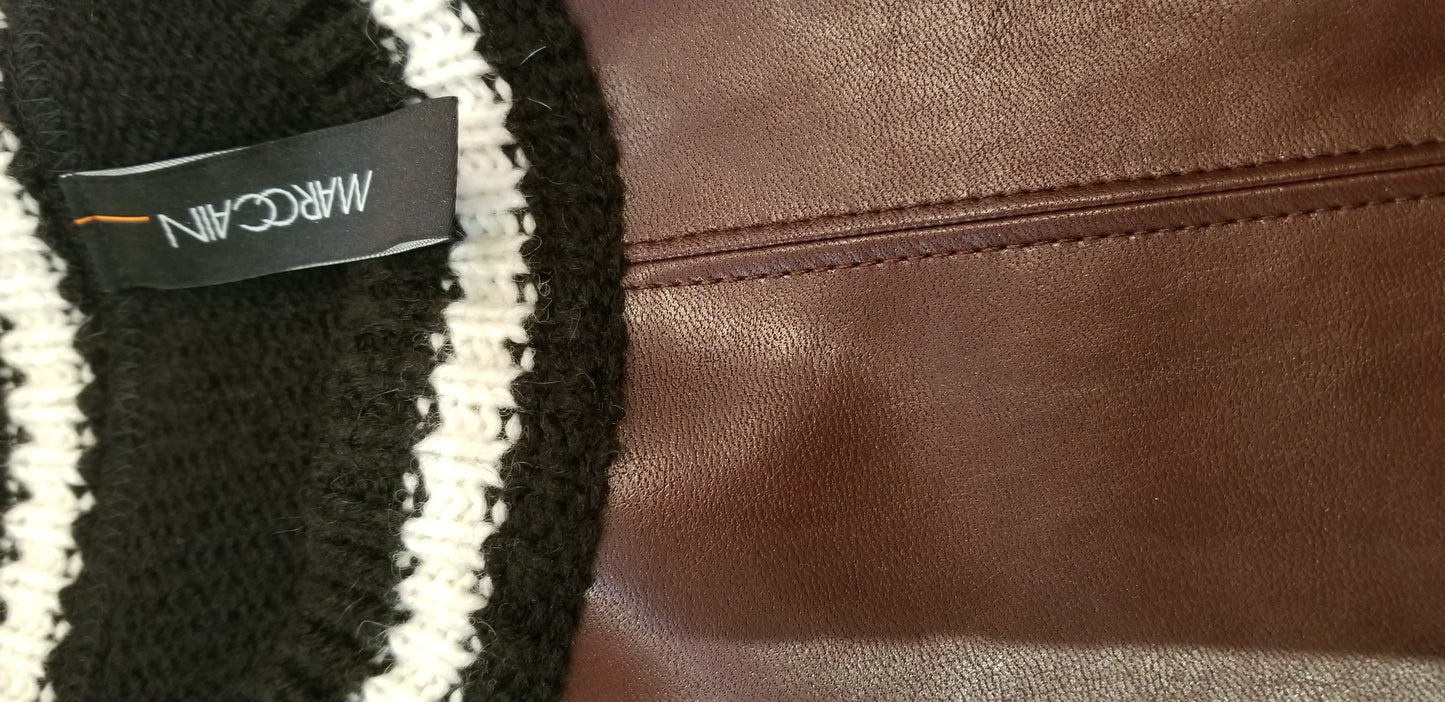Marccain leather blouse showcasing luxurious leather and cozy knitted fabric design.