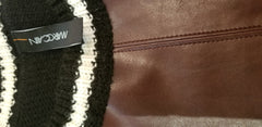Marccain leather blouse showcasing luxurious leather and cozy knitted fabric design.