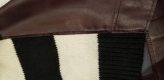 Close-up of Marccain Leather Blouse showcasing leather and knitted fabric blend, highlighting luxurious design elements.