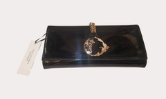 Versace Clutch featuring a classic black and gold design, perfect for elevating party and formal outfits.