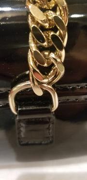 Close-up of Versace Clutch featuring classic black design and elegant gold chain detail.