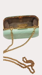 Versace Clutch in light green with gold chain, showcasing elegance and versatility for any party outfit.