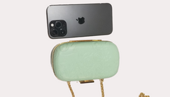 Versace Clutch in light green with gold chain alongside an iPhone, perfect for glam party looks.