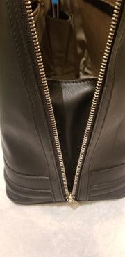 Close-up of the Versace Black Handbag showcasing the sleek zipper detail and quality leather interior.