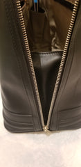 Close-up of the Versace Black Handbag showcasing the sleek zipper detail and quality leather interior.