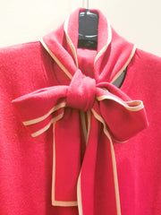 Escada blouse close-up featuring a stylish tie design in red with cream trim for a versatile and comfortable look.
