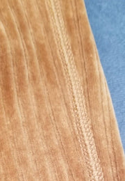 Close-up of Marccain brown corduroy fabric showcasing its soft texture and fine detailing.