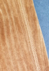 Close-up of Marccain brown corduroy fabric showcasing its soft texture and fine detailing.