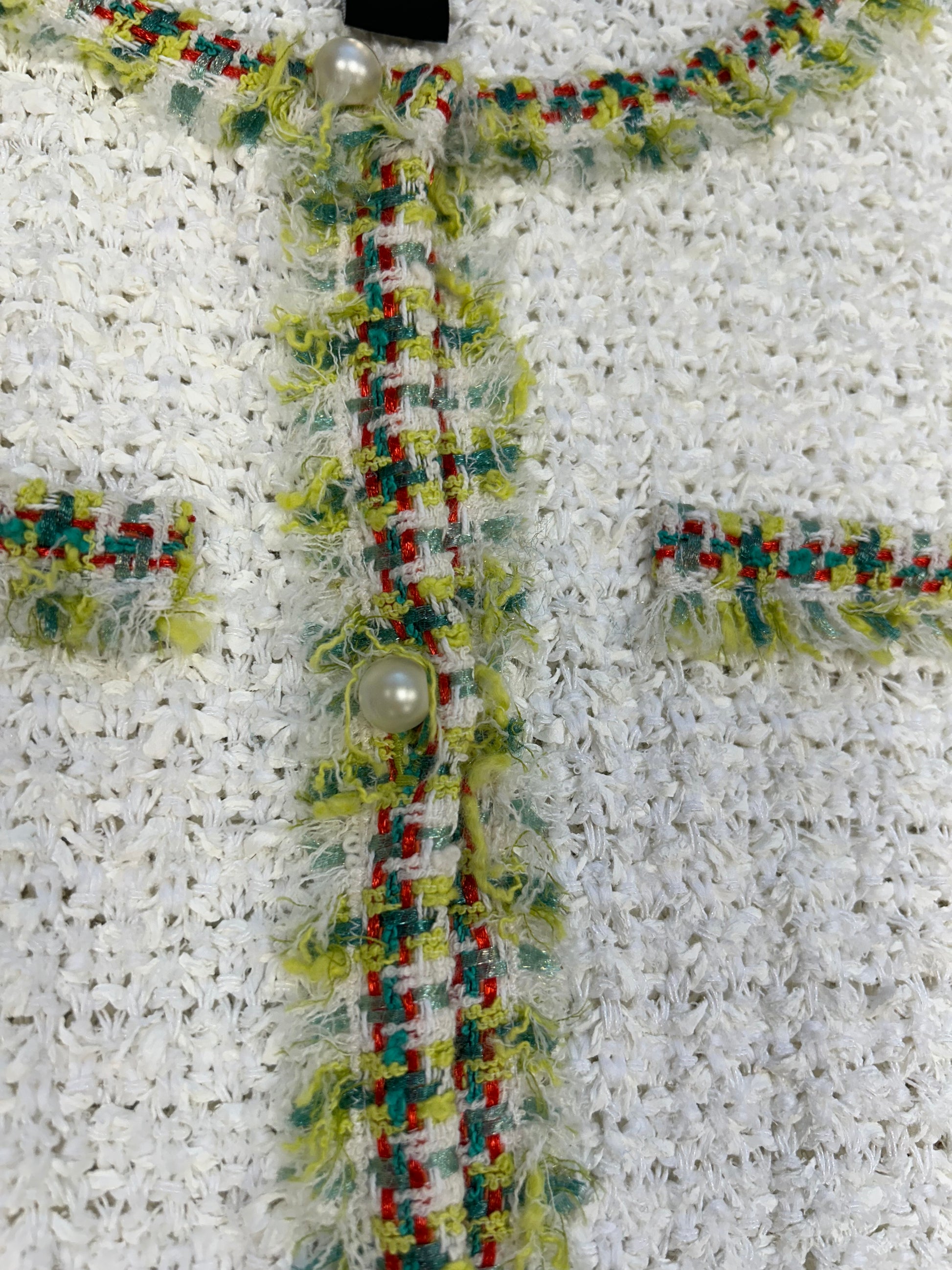 Close-up of Marccain Whit Spring Jacket featuring colorful neckline, cuffs, and pearl buttons for stylish spring attire.