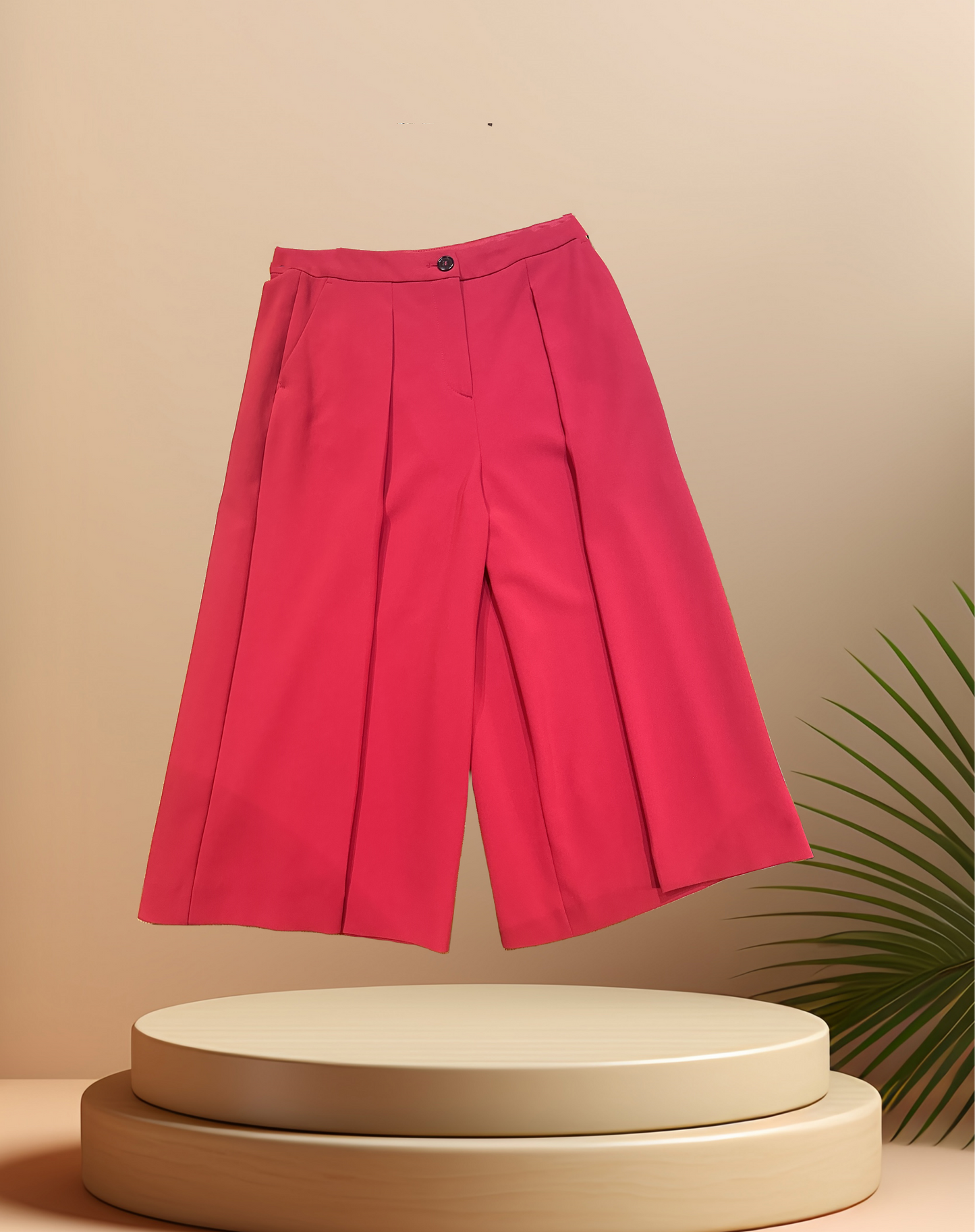 Marccain red flared pants displayed on a circular pedestal, showcasing a relaxed fit and stylish design.