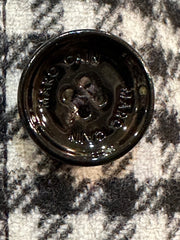 Close-up of Marccain black and white checked coat button, showcasing quality craftsmanship and design details.