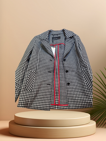 Marccain black and white checked coat showcasing stylish design and quality fabric on a minimalist display.