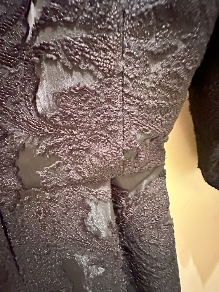Close-up of the elegant Seventy Black Lace Dress highlighting intricate lace detailing and luxurious fabric.