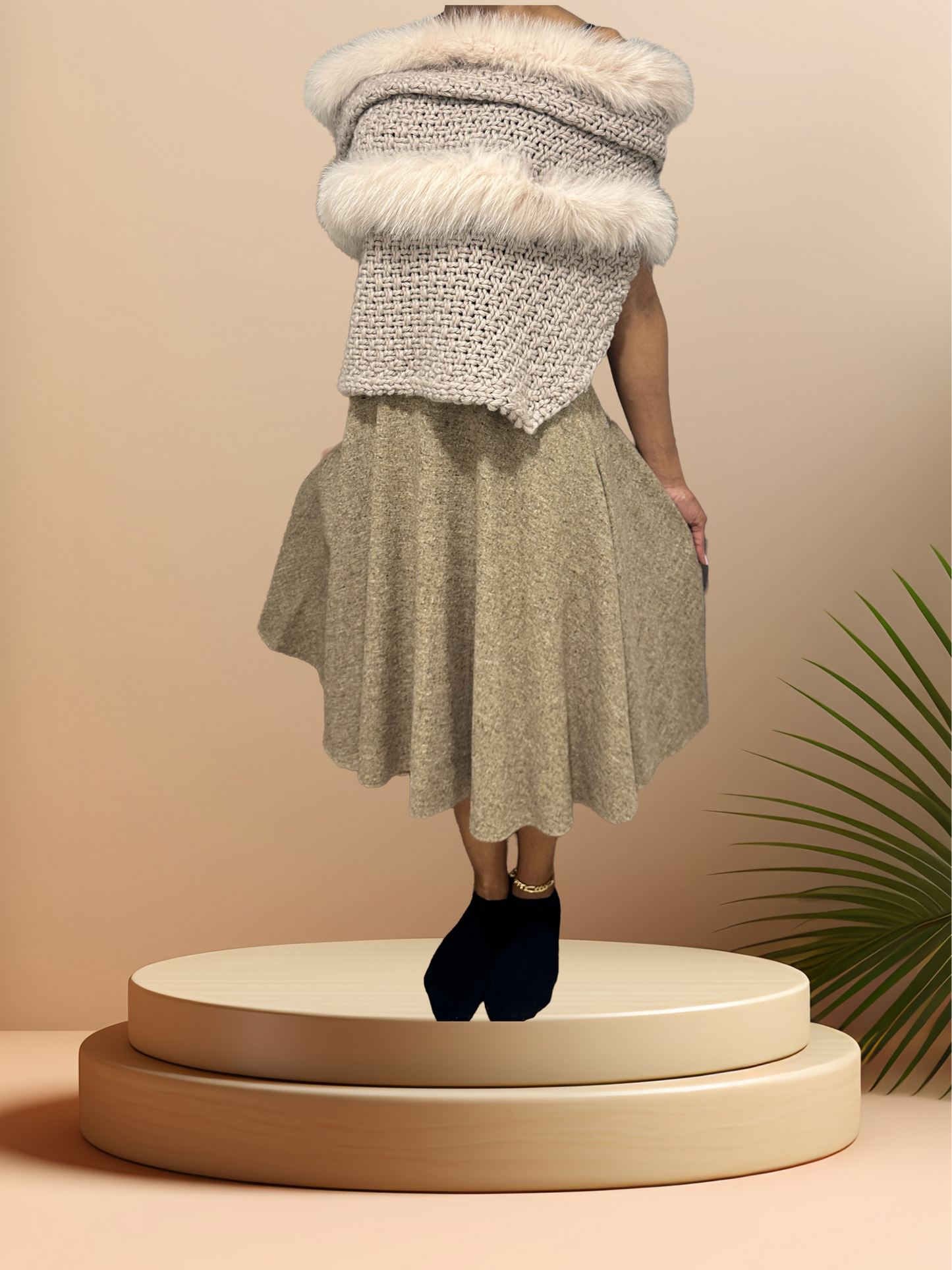Stylish Tricot Chic Shawl with wool and fur, paired with a flowing skirt on a display stand.