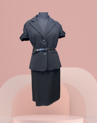 Elegant black blazer and skirt set showcased on a mannequin against a pastel background.