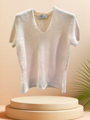 Marccain creamy blouse on display, made from 64% wool, perfect for warmth and style in winter and spring.