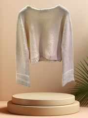 Marccain Creamy Cardigan displayed on a podium, showcasing its lightweight merino wool blend for stylish winter layering.