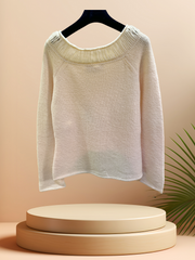 Marccain Sweater in creamy color, featuring a thread neckline and ribbed cuffs, displayed on a hanger.