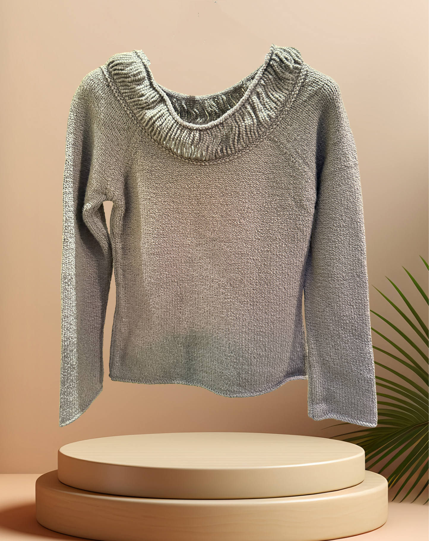 Marccain sweater in gray with a thread neck line and ribbed cuffs, showcased on a pedestal with a minimalistic background.