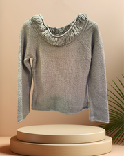 Marccain sweater in gray with a thread neck line and ribbed cuffs, showcased on a pedestal with a minimalistic background.
