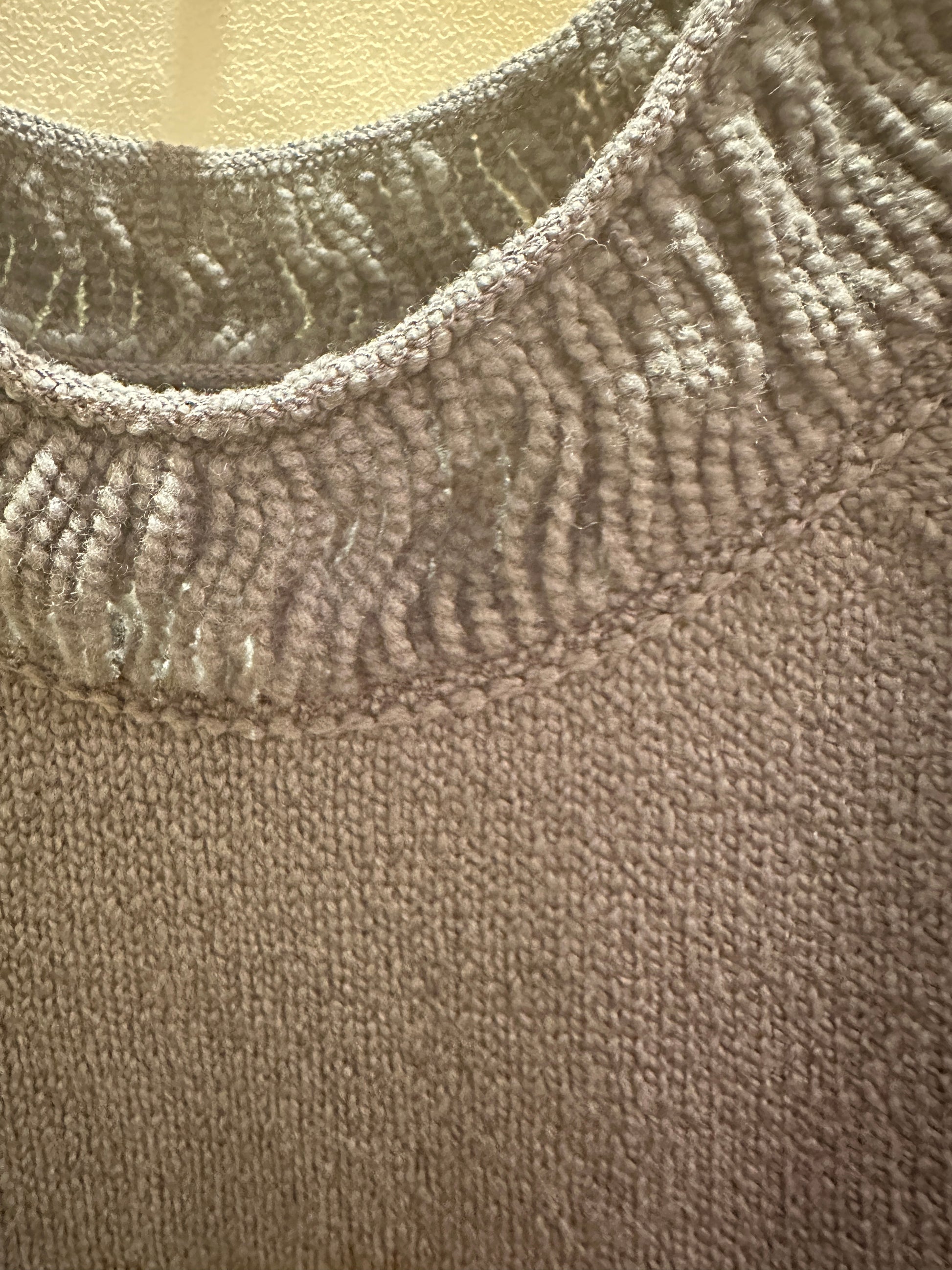 Close-up of the thread neckline detail on a Marccain Sweater in gray, showcasing premium fabric and craftsmanship.