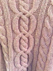 Close-up of the Escada pink sweater's intricate cable knit design, showcasing its soft texture and cozy fabric.