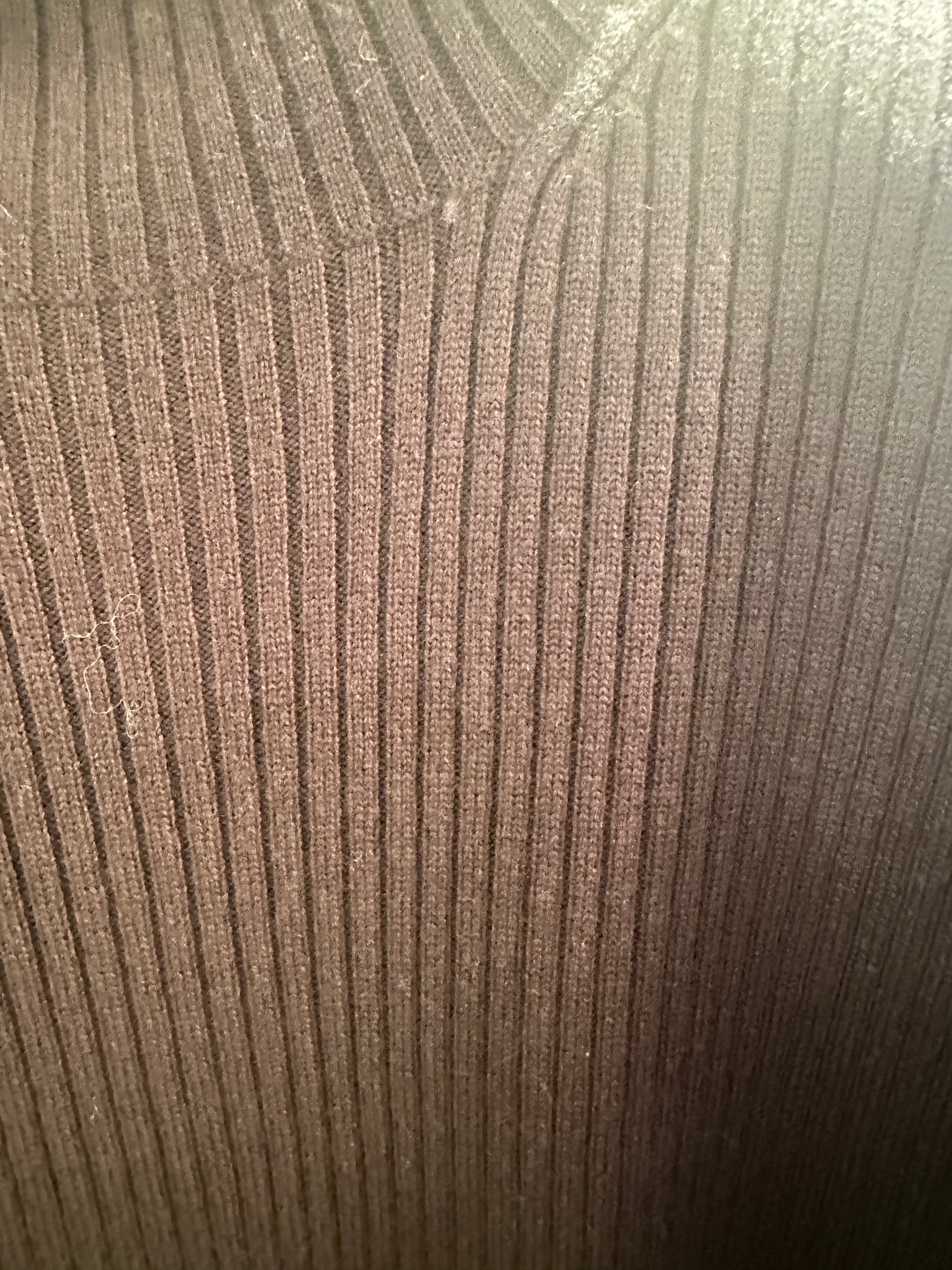 Close-up of a ribbed Escada blouse made from 90% new wool and 10% cashmere in a rich brown color.