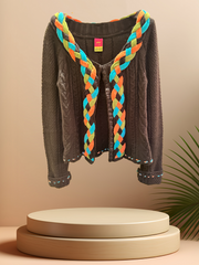 Save the Queen Cardigan featuring a colorful braided line, adding style to any outfit. Made of 50% Wool and 50% Acrylic.