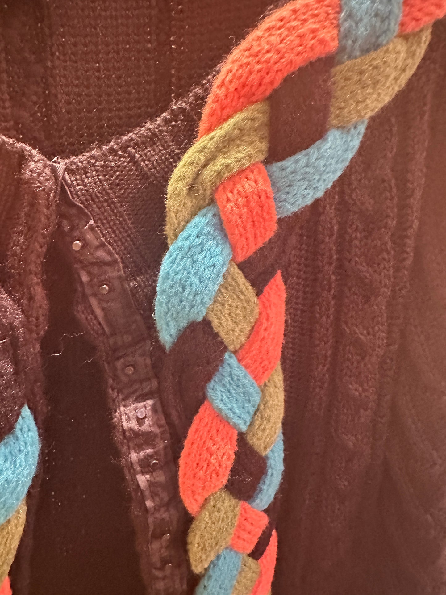 Save the Queen Cardigan featuring a colorful braided accent, perfect for adding style to any outfit.