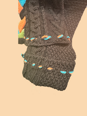 Close-up of the Save the Queen Cardigan sleeve, showcasing braided details and colorful accents.