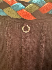 Close-up of Save the Queen Cardigan featuring braid line detail and unique tag, highlighting stylish knitwear craftsmanship.
