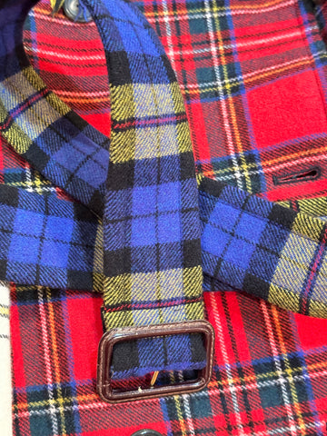 Close-up detail of a Moschino tartan coat featuring colorful plaid fabric and a stylish buckle.