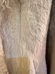 Close-up of the soft rabbit fur texture of an Essential Long Fur Coat featuring a unique mosaic design.