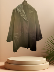Versace black coat with detachable rabbit fur lining displayed on a podium, showcasing its stylish design.