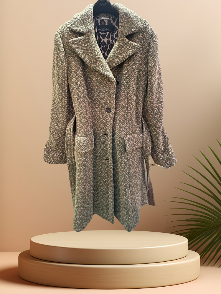 Marccain long coat in wool blend with vintage cut and detachable belt, styled on a minimal display.