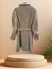Back view of a Marccain long coat with a vintage design, featuring a detachable belt and wool blend fabric.