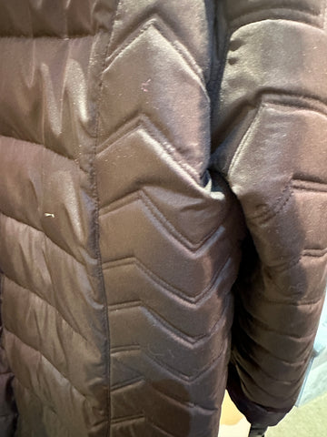 Close-up of the Apropos Long Down Coat showcasing its stylish chevron quilted design in black.