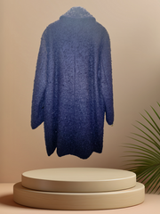 Marccain Black Long Coat displayed on a round pedestal, showcasing its unique texture and stylish design for winter.