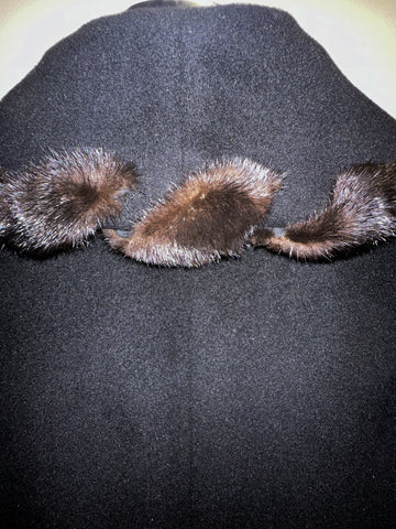 Close-up of the Mallia Black Fur Braid Collar Long Coat, featuring luxurious black fabric and elegant fur braid detailing.