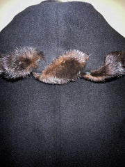 Close-up of the Mallia Black Fur Braid Collar Long Coat, featuring luxurious black fabric and elegant fur braid detailing.